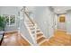 Modern white staircase with wooden steps and hardwood floors at 2588 High Hammock Rd, Johns Island, SC 29455