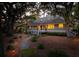 House exterior at night, showcasing warm interior lighting at 2588 High Hammock Rd, Johns Island, SC 29455
