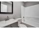 Clean bathroom with gray vanity, white tub, and black framed mirror at 2674 Houston St, North Charleston, SC 29405