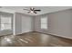 Well-lit bedroom with hardwood floors, double doors, and two windows at 2674 Houston St, North Charleston, SC 29405