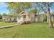 Tan bungalow with a walkway and landscaping at 2674 Houston St, North Charleston, SC 29405
