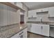 Modern kitchen with white shaker cabinets, granite countertops, and stainless steel appliances at 2674 Houston St, North Charleston, SC 29405