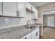 White cabinets, granite countertops, and a stainless steel sink at 2674 Houston St, North Charleston, SC 29405