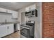 Modern kitchen with white cabinets, granite counters, and stainless steel appliances at 2674 Houston St, North Charleston, SC 29405