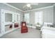 Bright bedroom with mirrored closet doors, window seating, and patterned wallpaper at 55 Rialto Rd, Mount Pleasant, SC 29464