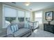 Well-lit Bedroom with crib, comfortable seating, and large windows at 4966 Ballantine Drive, Summerville, SC 29485