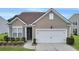 Tan house with white garage door and landscaping at 126 Harbor Trace Ln, Summerville, SC 29486