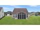 House back view with screened porch and yard at 126 Harbor Trace Ln, Summerville, SC 29486