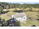 White barn with metal roof and adjacent fenced pasture at 203 Hickory Nut Drive, Harleyville, SC 29448