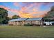Brick ranch house with metal roof and landscaping at 203 Hickory Nut Drive, Harleyville, SC 29448