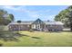 Brick house with a metal roof and a large grassy backyard at 203 Hickory Nut Drive, Harleyville, SC 29448