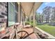 Side view of the home's porch, showcasing the brickwork and landscaping at 203 Hickory Nut Drive, Harleyville, SC 29448
