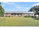Brick ranch house with metal roof and landscaped yard at 203 Hickory Nut Drive, Harleyville, SC 29448