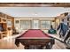 Game room with pool table and natural light from large windows at 203 Hickory Nut Drive, Harleyville, SC 29448