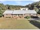 Ranch style brick home with metal roof and a large yard at 203 Hickory Nut Drive, Harleyville, SC 29448