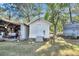 Small white outbuilding with a single door and steps at 203 Hickory Nut Drive, Harleyville, SC 29448