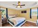 Spacious main bedroom with hardwood floors, ceiling fan, and large windows at 203 Hickory Nut Drive, Harleyville, SC 29448