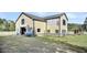 Large yellow barn with stalls and fenced area at 203 Hickory Nut Drive, Harleyville, SC 29448