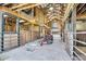 Barn aisle with multiple stalls and tractor at 203 Hickory Nut Drive, Harleyville, SC 29448