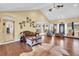 Living room with hardwood floors, vaulted ceiling and access to kitchen and entry at 203 Hickory Nut Drive, Harleyville, SC 29448