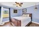 Bedroom with a wooden sleigh bed and a view of the backyard at 203 Hickory Nut Drive, Harleyville, SC 29448