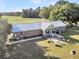 Brick home with metal roof, sunroom, patio, and spacious yard at 203 Hickory Nut Drive, Harleyville, SC 29448