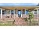 Brick front entry with a charming covered porch and steps at 203 Hickory Nut Drive, Harleyville, SC 29448