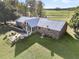 Brick home with metal roof, sunroom, and flagstone patio at 203 Hickory Nut Drive, Harleyville, SC 29448