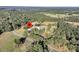 Aerial view of a house on a large lot with a pond and mature trees at 203 Hickory Nut Drive, Harleyville, SC 29448