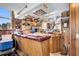 Well-stocked wet bar with wood cabinetry and granite countertop at 203 Hickory Nut Drive, Harleyville, SC 29448