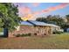 Brick ranch house with metal roof and landscaping at 203 Hickory Nut Drive, Harleyville, SC 29448