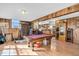 Basement game room features a pool table, bar, and ample space for entertainment at 203 Hickory Nut Drive, Harleyville, SC 29448