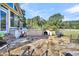 Spacious flagstone patio with a grill and an outdoor fireplace at 203 Hickory Nut Drive, Harleyville, SC 29448