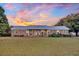 Brick ranch house with metal roof and landscaped yard at 203 Hickory Nut Drive, Harleyville, SC 29448