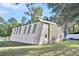 Metal outbuilding with windows and a single door at 203 Hickory Nut Drive, Harleyville, SC 29448