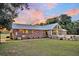 Brick home with sunroom and large backyard at 203 Hickory Nut Drive, Harleyville, SC 29448