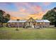 Brick home with a sunroom, patio, and a large backyard at 203 Hickory Nut Drive, Harleyville, SC 29448