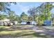 View of property with several outbuildings and landscaping at 203 Hickory Nut Drive, Harleyville, SC 29448