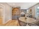 Bright dining area with a round table, gray cabinetry, and hardwood floors at 176 Congress St, Charleston, SC 29403