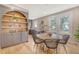 Charming dining area with a round table, built-in shelving, and hardwood floors at 176 Congress St, Charleston, SC 29403