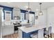 Modern kitchen with gray cabinets, stainless steel appliances and a blue island at 681 Mclernon Trce, Johns Island, SC 29455