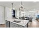 Open concept kitchen with island, stainless steel appliances, and views into the living room at 681 Mclernon Trce, Johns Island, SC 29455