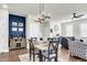 Dining area with a gray table, four chairs, and a modern chandelier at 681 Mclernon Trce, Johns Island, SC 29455
