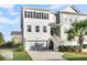 Two-story townhome with white and gray siding, a garage, and a palm tree at 681 Mclernon Trce, Johns Island, SC 29455