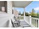 Covered porch with white railings, gray chairs, and a striped rug at 681 Mclernon Trce, Johns Island, SC 29455