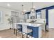 Eat-in kitchen with gray cabinets, stainless steel appliances, and a blue accent wall at 681 Mclernon Trce, Johns Island, SC 29455