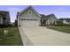 Two-car garage with paved driveway and landscaping at 119 Camelia Park Ln, Summerville, SC 29486