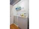 Bright laundry room with washer, dryer, and ample shelving at 108 W 2Nd St, Folly Beach, SC 29439