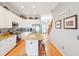 Open concept kitchen with island, stainless steel appliances and granite countertops at 108 W 2Nd St, Folly Beach, SC 29439