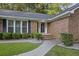 Brick house with a manicured lawn, shrubs, and a walkway leading to the entrance at 205 Turtle Cove Rd, Summerville, SC 29485